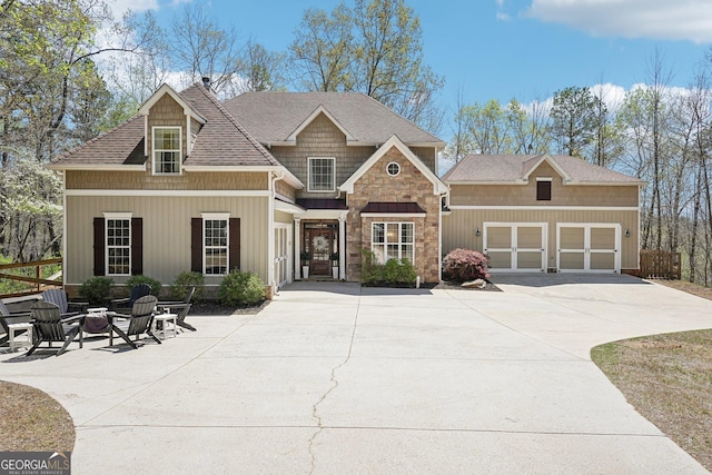 185 Starlight Dr, Dahlonega, GA 30533 - craftsman inspired home featuring concrete driveway, an outdoor fire pit, a garage, and roof with shingles