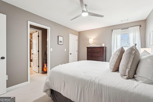 185 Starlight Dr, Dahlonega, GA 30533 - bedroom featuring ceiling fan, ensuite bathroom, visible vents, light carpet, and baseboards