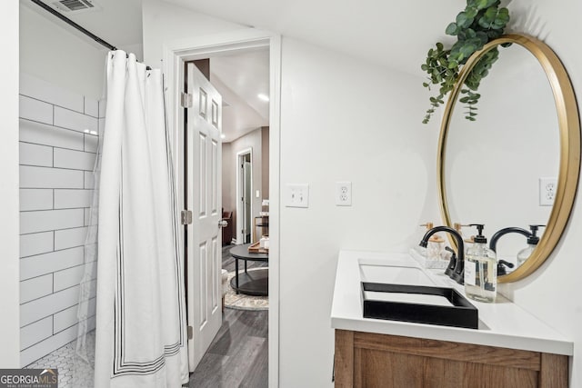 185 Starlight Dr, Dahlonega, GA 30533 - full bathroom with visible vents, a shower with curtain, a sink, double vanity, and wood finished floors