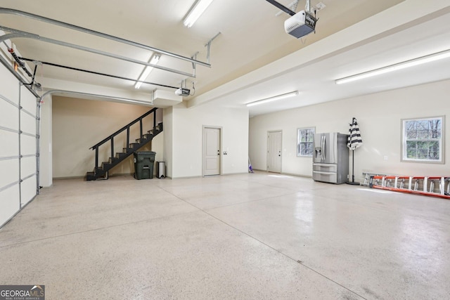 185 Starlight Dr, Dahlonega, GA 30533 - garage featuring stainless steel refrigerator with ice dispenser and a garage door opener