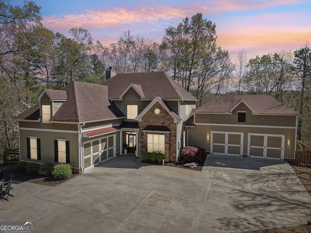 185 Starlight Dr, Dahlonega, GA 30533 - craftsman-style home with a chimney, stone siding, driveway, and roof with shingles