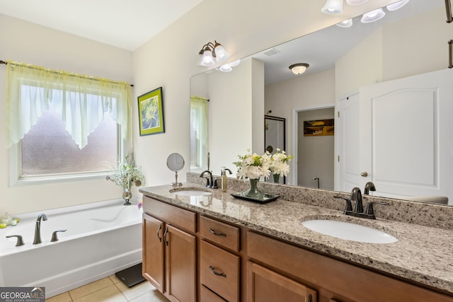 bathroom featuring tile patterned floors, double vanity, a bath, and a sink