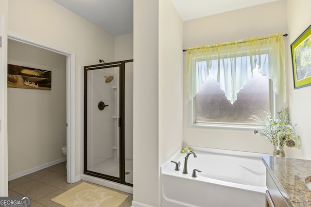 bathroom with vanity, tile patterned floors, toilet, a shower stall, and a bath