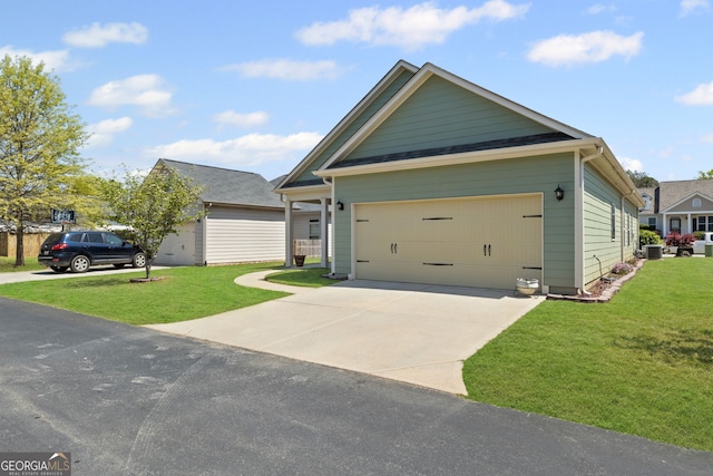 view of front facade with concrete driveway, a front yard, and an attached garage