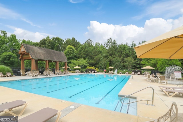 pool featuring a gazebo, a patio area, and fence