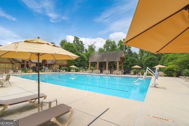community pool featuring a patio and fence