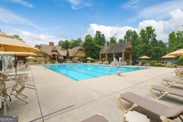 community pool featuring a patio area and fence