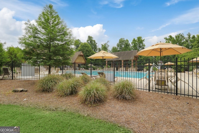pool featuring a patio area and fence