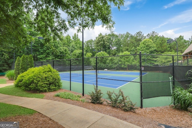 view of tennis court with fence