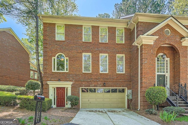 view of front of property featuring brick siding, an attached garage, and concrete driveway