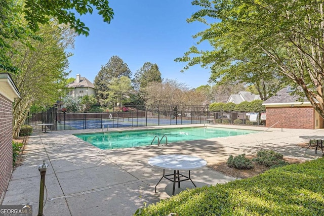 view of pool featuring fence