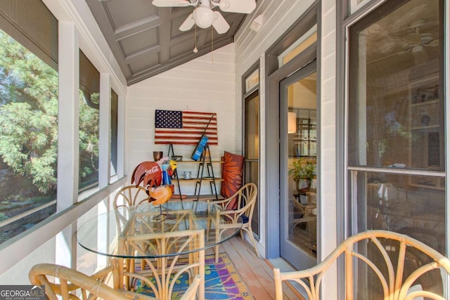 sunroom with a ceiling fan and wood finished floors