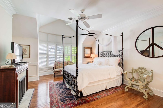 bedroom with light wood-type flooring, lofted ceiling, ornamental molding, and visible vents
