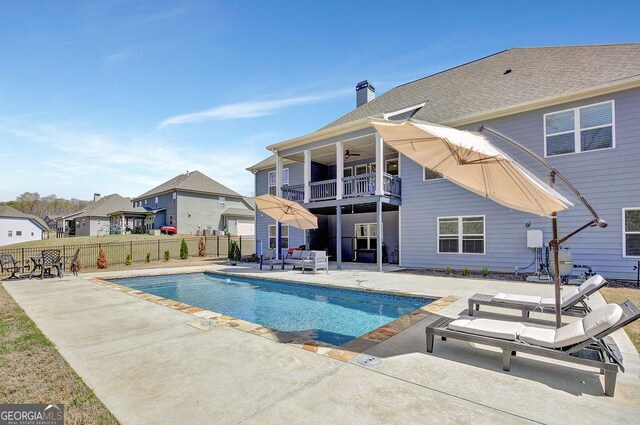 view of pool featuring a patio area, fence, a fenced in pool, and a ceiling fan