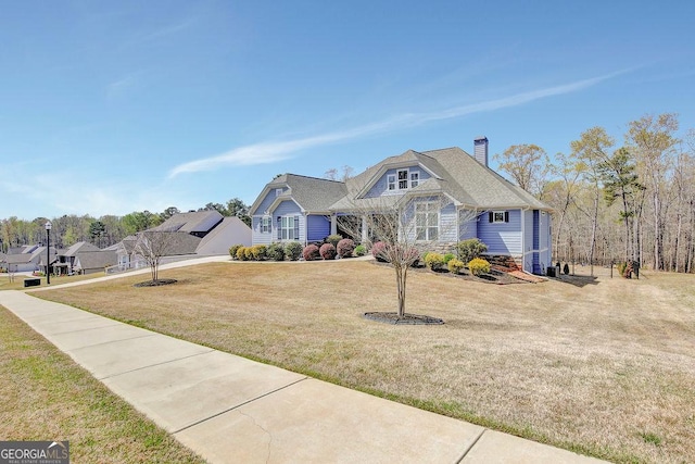 view of front of property with a front lawn and a chimney
