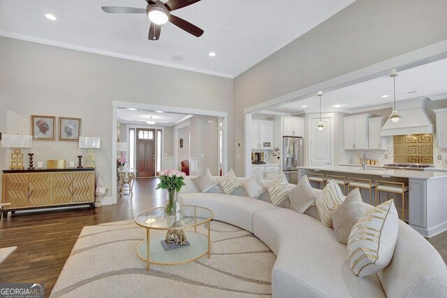 living area with dark wood-style flooring, recessed lighting, crown molding, visible vents, and ceiling fan