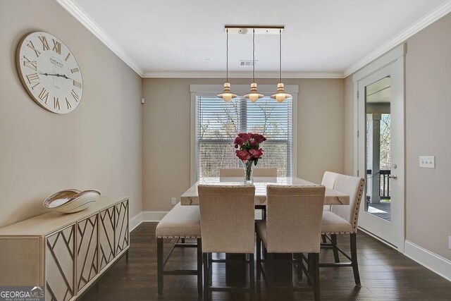 dining room with ornamental molding, baseboards, and dark wood finished floors
