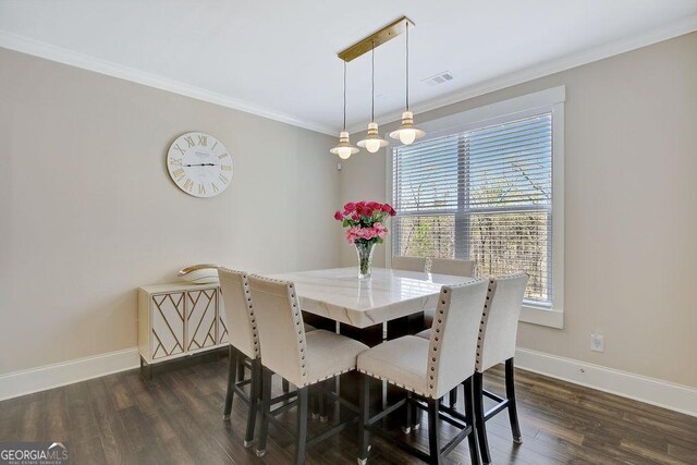 dining space with crown molding, baseboards, and dark wood finished floors