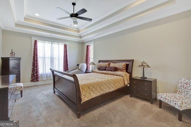 bedroom with ornamental molding, a ceiling fan, a tray ceiling, recessed lighting, and light carpet