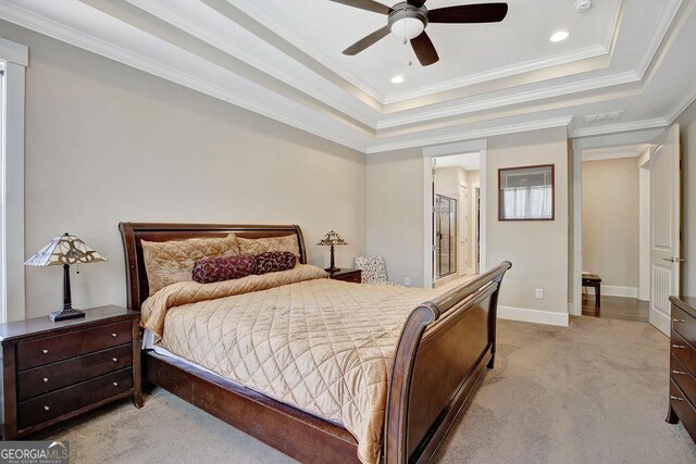 bedroom with light carpet, baseboards, ornamental molding, and a raised ceiling