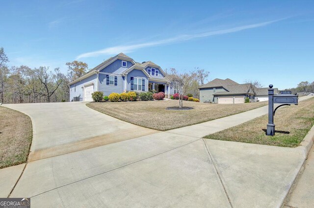 traditional-style home with a front lawn, a garage, and driveway