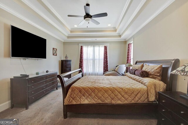 bedroom with ceiling fan, light colored carpet, ornamental molding, and a raised ceiling