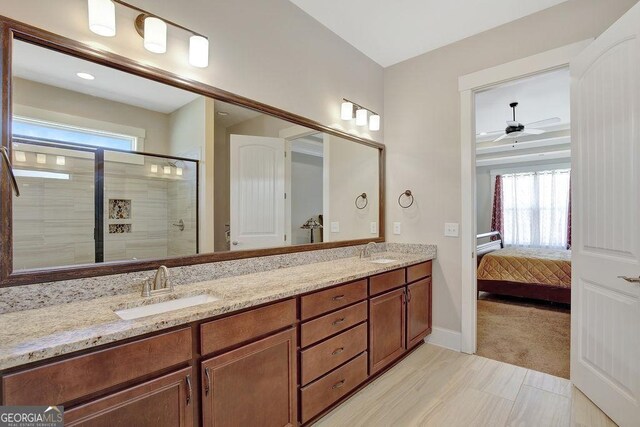 full bathroom with a shower stall, a healthy amount of sunlight, and a sink