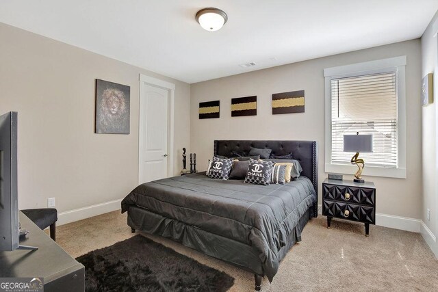 bedroom with carpet floors, baseboards, and visible vents
