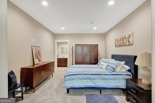 bedroom featuring light colored carpet, ensuite bathroom, visible vents, and recessed lighting