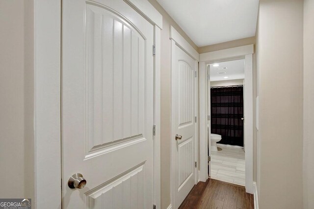hallway with dark wood-style floors and recessed lighting