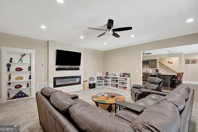 living room with ceiling fan, recessed lighting, and light colored carpet