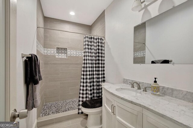 full bathroom with toilet, a stall shower, vanity, and recessed lighting