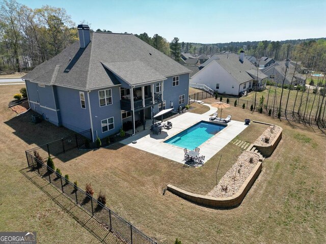 view of pool with central AC, a yard, a fenced backyard, a patio area, and a fenced in pool
