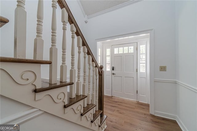 3775 Belle Glade Trl, Snellville, GA 30039 - foyer with crown molding, stairs, and wood finished floors