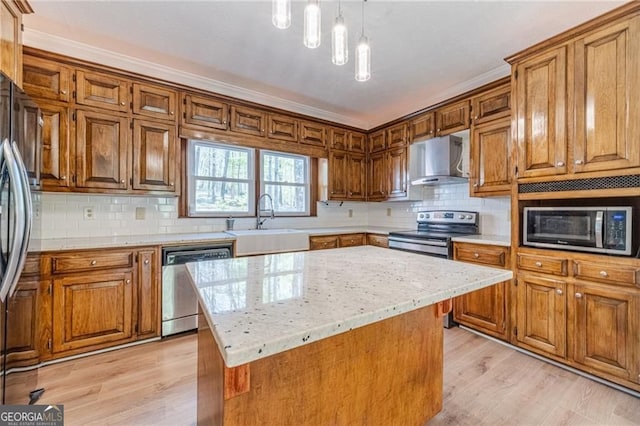 3775 Belle Glade Trl, Snellville, GA 30039 - kitchen featuring appliances with stainless steel finishes, wall chimney range hood, light wood-style floors, brown cabinets, and decorative backsplash