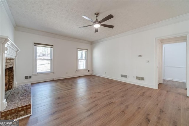 3775 Belle Glade Trl, Snellville, GA 30039 - unfurnished living room with ceiling fan, light wood-style floors, a textured ceiling, a brick fireplace, and ornamental molding
