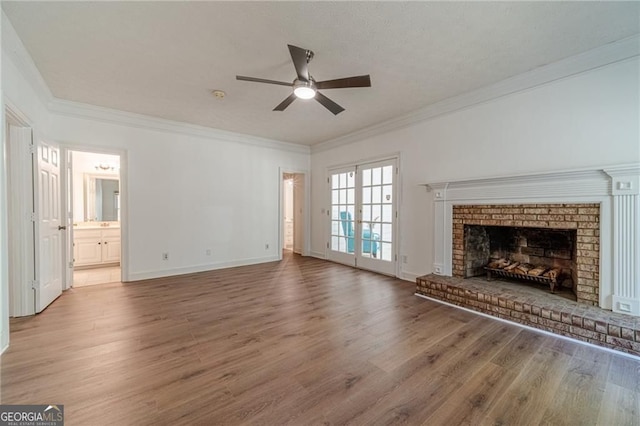 3775 Belle Glade Trl, Snellville, GA 30039 - unfurnished living room with ceiling fan, wood finished floors, a brick fireplace, and crown molding
