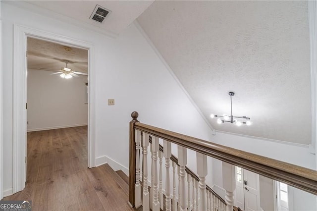 3775 Belle Glade Trl, Snellville, GA 30039 - hallway with a chandelier, light wood finished floors, a textured ceiling, an upstairs landing, and vaulted ceiling