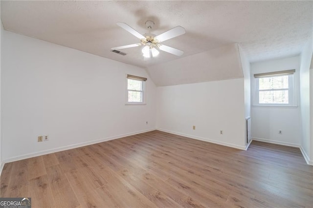 3775 Belle Glade Trl, Snellville, GA 30039 - additional living space with light wood-style floors, a textured ceiling, a ceiling fan, and vaulted ceiling