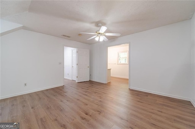 3775 Belle Glade Trl, Snellville, GA 30039 - spare room with light wood-style floors, a ceiling fan, and a textured ceiling