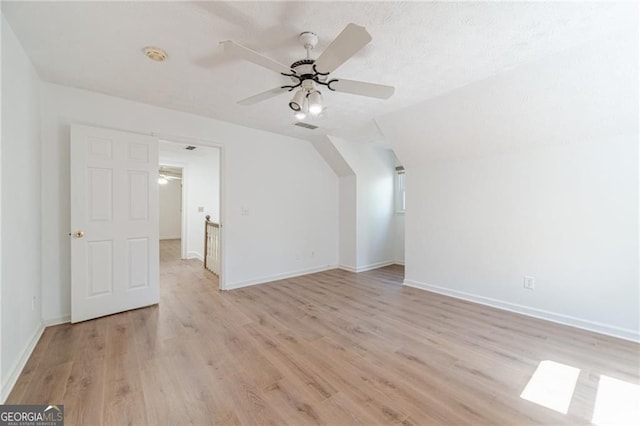 3775 Belle Glade Trl, Snellville, GA 30039 - bonus room with ceiling fan, light wood-style floors, lofted ceiling, and a textured ceiling