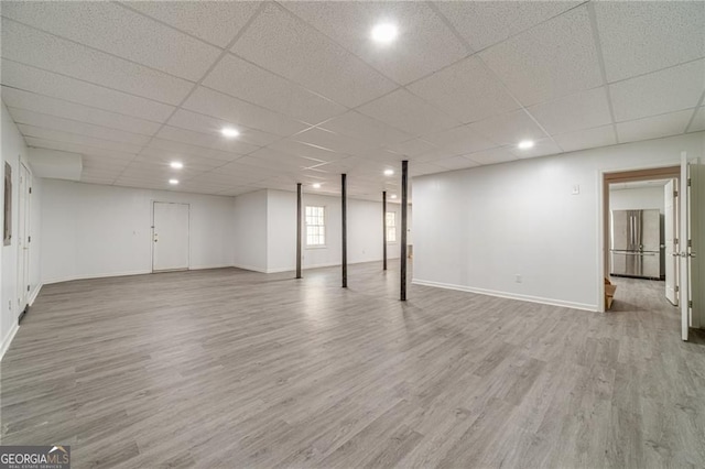 3775 Belle Glade Trl, Snellville, GA 30039 - basement with light wood-style flooring, freestanding refrigerator, a paneled ceiling, and recessed lighting