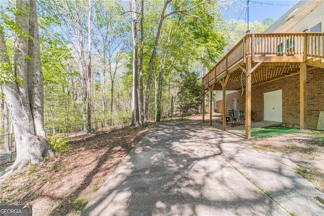 3775 Belle Glade Trl, Snellville, GA 30039 - view of patio with a wooden deck and concrete driveway