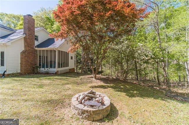 3775 Belle Glade Trl, Snellville, GA 30039 - view of grassy yard with a sunroom and a fire pit