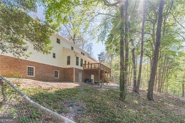 3775 Belle Glade Trl, Snellville, GA 30039 - back of property featuring a deck, a patio, and brick siding