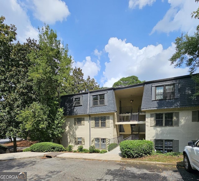 173 Amherst Pl NW, Atlanta, GA 30327 - view of front of property featuring roof with shingles, stucco siding, and mansard roof