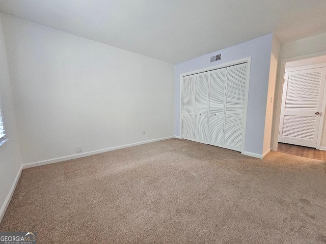 173 Amherst Pl NW, Atlanta, GA 30327 - unfurnished bedroom featuring baseboards, carpet, and a closet