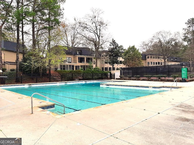 173 Amherst Pl NW, Atlanta, GA 30327 - community pool with fence, a patio area, and a residential view