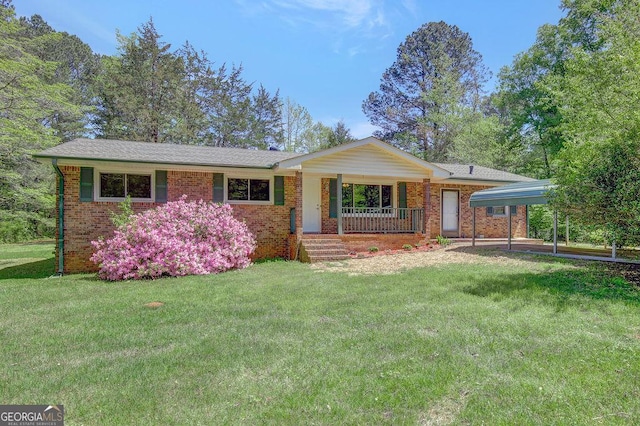 ranch-style house with a detached carport, covered porch, a front lawn, and brick siding