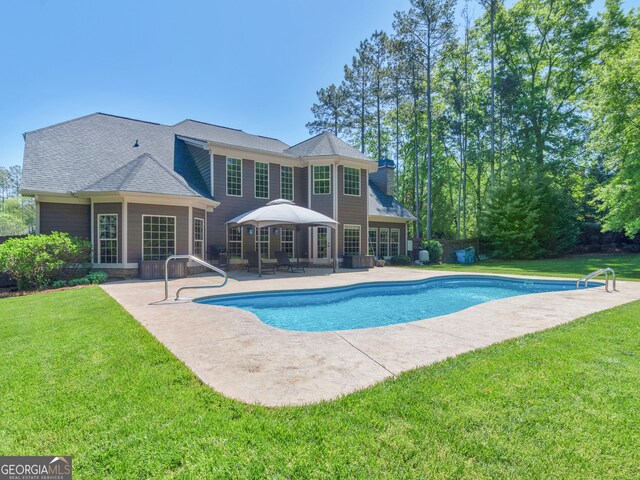 view of pool featuring a patio area, a fenced in pool, and a yard